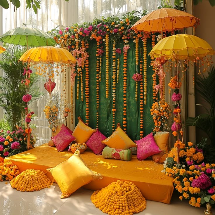 Mehendi photobooth setup with yellow parasols and marigold strings